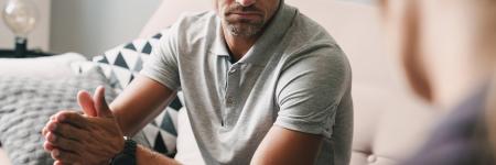 man having a serious conversation with another person