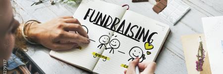 an open book with the word "fundraising"