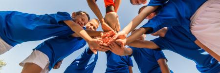 a group of kids huddled in a circle
