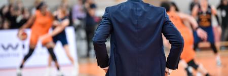 basketball coach looking at basketball game