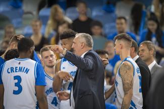 Basketball coach talking to players